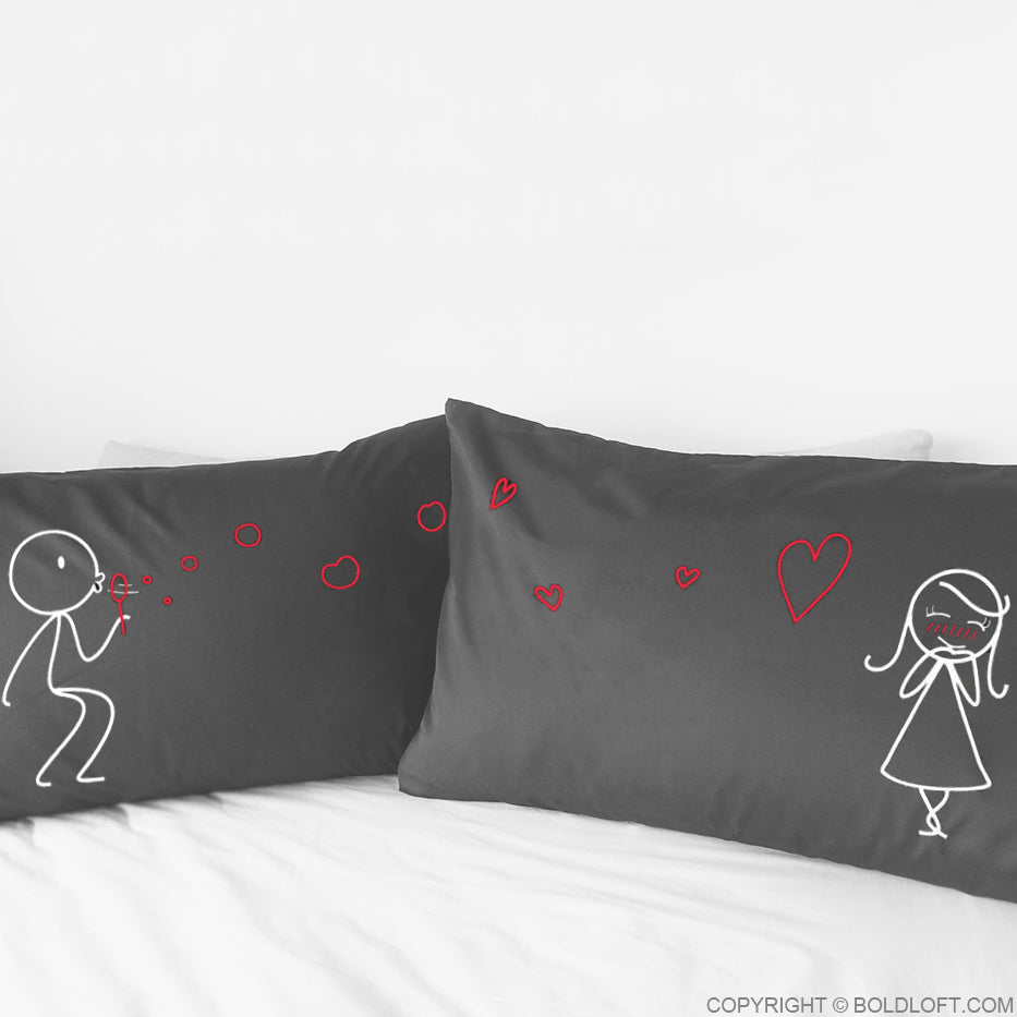 From My Heart to Yours™ Couple Pillowcases in Grey, his and her pillowcases feature a male stick figure blows love bubbles to a female stick figure
